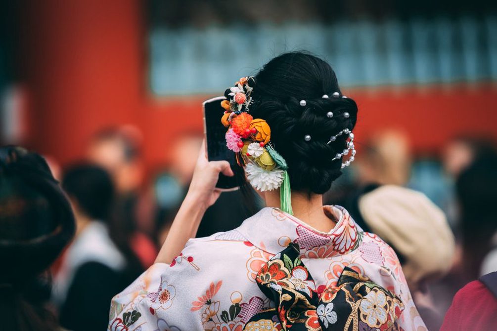 A floral clip placed beside a low bun