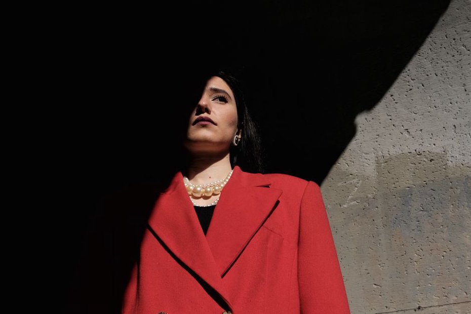 A pearl barrette paired with a tailored wool coat