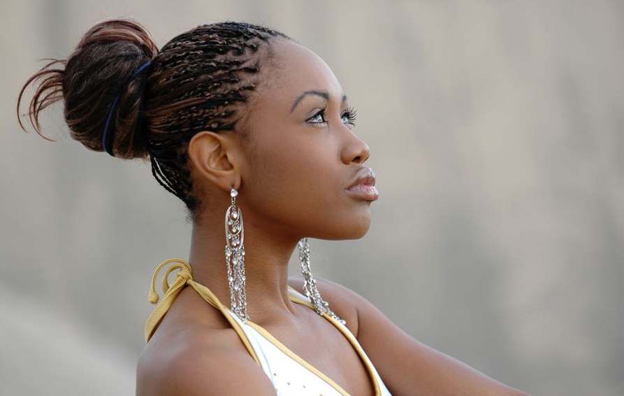 carved wooden hair fork holding a braided updo in soft natural light