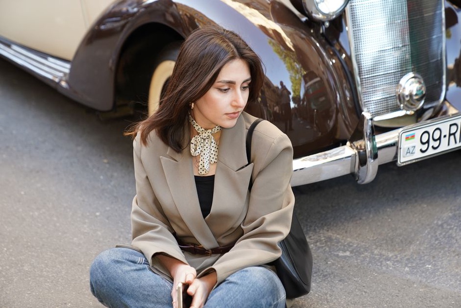 A narrow scarf adds colour beside simple tailoring