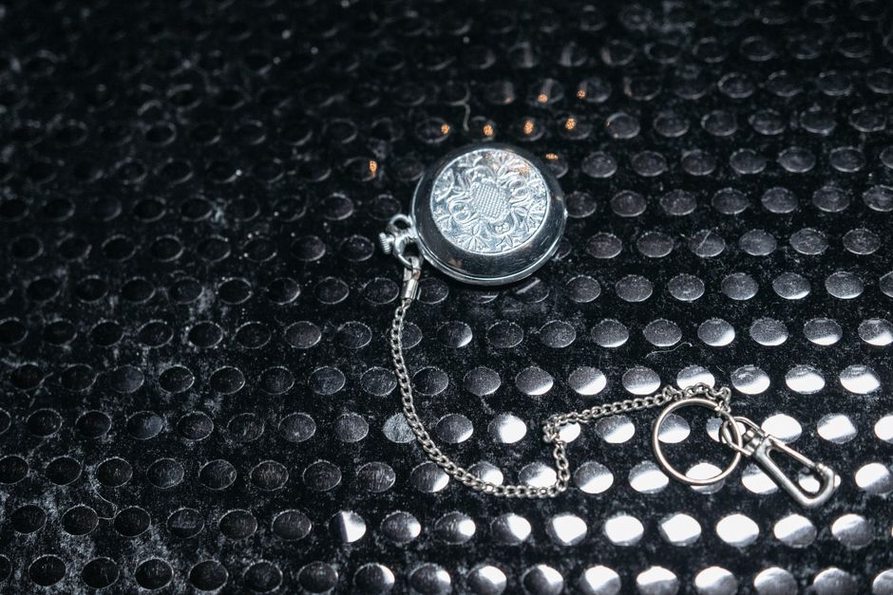 Woven hair preserved beneath a locket’s glass cover
