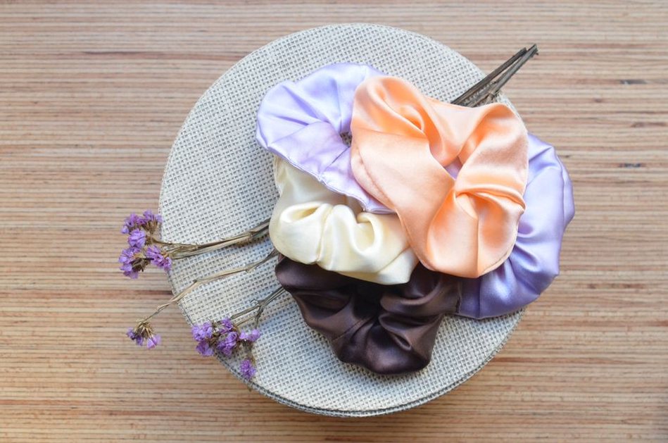 Satin scrunchies and broad bows show their shape