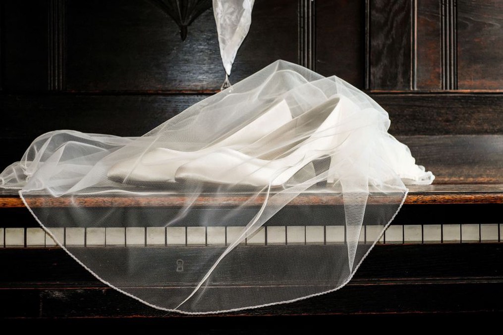 Curved comb resting against a folded bridal veil